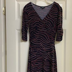 Beautiful cocktail dress by BCX. Black with red /white dots in a wave pattern.